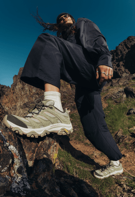 Two hikers wearing Merrell Moab 3 shoes on a rocky trail.